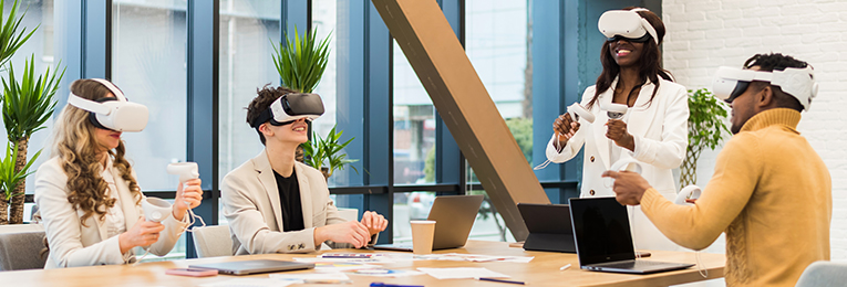 four people seen using VR lenses and controls and testing projects at there office space